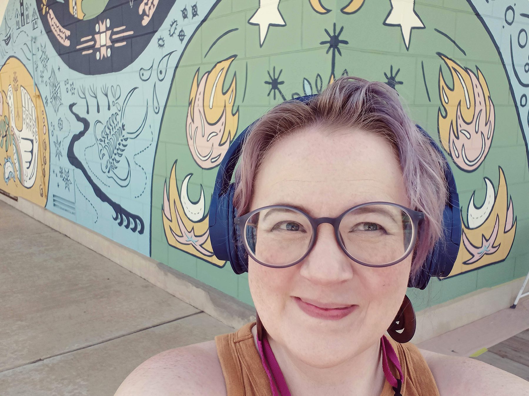 Lauren Bonney snaps a selfie at her mural, Together in Decorah