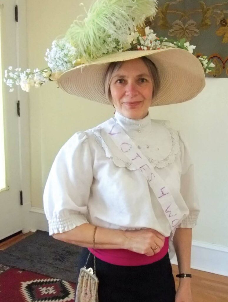 Jane Peck stands dressed in historical clothing