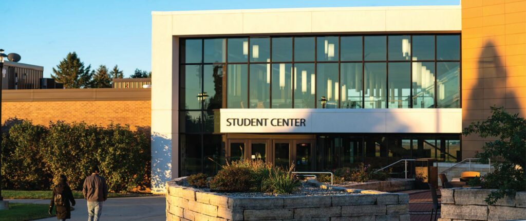 Students walking towards the student center of Northeast Iowa Community College where Dr. Liang Wee Chee just retired from the role of president